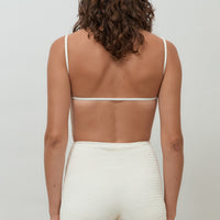 back hakea textured cream Terrain One Piece shorty surfsuit — sustainable swimwear designed for support and comfort in the surf, flattering one piece surf suit for active women.