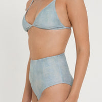 woman wearing flattering high waist bikini bottoms in blue green colour, sustainable swimwear for active women